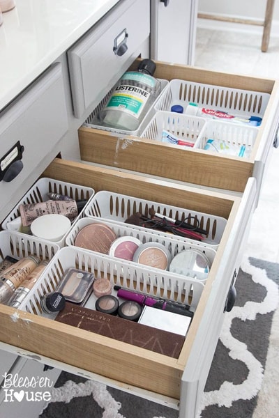 Bathroom drawers with organizer containers filled with make-up products