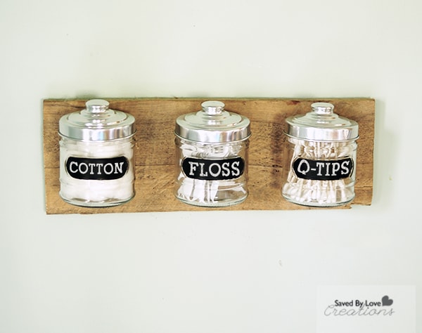 jars on wood storing q-tips and cotton rounds
