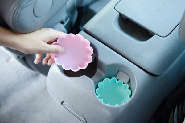 Silicone cupcake liners inside cup holders in a car