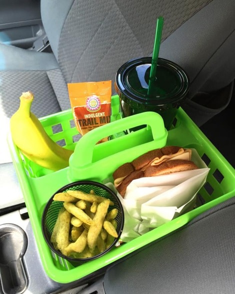 A green shower caddy containing food and drinks